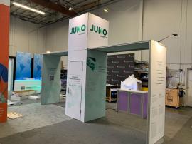 RENTAL: Modified RE-9195 Island Design with Gravitee Storage Closet with Locking Door at 42" x 42" x 142.5" High, (2) Gravitee Arch Canopies at 84" Long x 95" High, (6) LED Arm Lights, Large Monitor Mount, 43" Monitor, RE-1567 Backlit Reception Counter, a